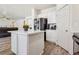 Bright, modern kitchen with a center island, stainless steel appliances, and hardwood floors at 564 Lampshire Ln, Pahrump, NV 89060