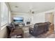 Comfortable living room featuring a brick fireplace, large windows, and stylish floors at 564 Lampshire Ln, Pahrump, NV 89060