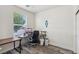 Bright home office features a large window, modern desk, and wood-look floors at 564 Lampshire Ln, Pahrump, NV 89060
