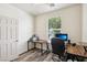 Well-lit home office featuring a large window and wood-look floors at 564 Lampshire Ln, Pahrump, NV 89060
