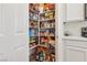 Walk-in pantry with shelves stocked with various food items and household supplies at 564 Lampshire Ln, Pahrump, NV 89060