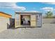 Interior view of shed with open doors, showcasing ample storage space and natural light at 564 Lampshire Ln, Pahrump, NV 89060