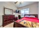 Comfortable bedroom with ceiling fan, carpet flooring, and large dresser at 5862 Bluthe Bridge Ave, Las Vegas, NV 89141