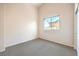 Spare bedroom featuring vaulted ceiling, carpet flooring, closet and a large window at 5862 Bluthe Bridge Ave, Las Vegas, NV 89141