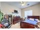Well-lit bedroom with ceiling fan, a large window, neutral walls, and furniture at 5862 Bluthe Bridge Ave, Las Vegas, NV 89141