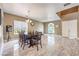 Open-concept dining room features tile floors, neutral walls, and staircase to second floor at 5862 Bluthe Bridge Ave, Las Vegas, NV 89141