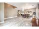 Open-concept dining room features tile floors, neutral walls, and staircase to second floor at 5862 Bluthe Bridge Ave, Las Vegas, NV 89141