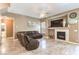 Comfortable living room features tile floors, a fireplace, and neutral walls at 5862 Bluthe Bridge Ave, Las Vegas, NV 89141