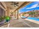 Relaxing covered patio with hammock overlooking a refreshing private pool and backyard at 5862 Bluthe Bridge Ave, Las Vegas, NV 89141