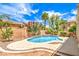 Inviting backyard pool surrounded by lush landscaping and a charming retaining wall at 5862 Bluthe Bridge Ave, Las Vegas, NV 89141