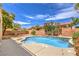 Beautiful private pool with waterfall feature, surrounded by mature trees and landscape at 5862 Bluthe Bridge Ave, Las Vegas, NV 89141