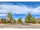 Charming community entrance featuring lush landscaping and well-maintained street view at 5862 Bluthe Bridge Ave, Las Vegas, NV 89141