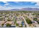Picture-perfect aerial view of a desert neighborhood with homes boasting pools and well-maintained lawns at 6214 Ebony Legends Ave, Las Vegas, NV 89131