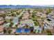 Gorgeous aerial view of community highlighting the two-story home, pool, court, desert landscape at 6214 Ebony Legends Ave, Las Vegas, NV 89131