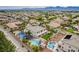 Beautiful community featuring a two-story home, pool, desert landscaping, and scenic views at 6214 Ebony Legends Ave, Las Vegas, NV 89131