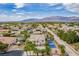 Beautiful community aerial showcasing the two-story home, pool, tennis court, and desert landscape at 6214 Ebony Legends Ave, Las Vegas, NV 89131