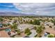 Expansive aerial view of a two-story home, pool, desert landscaping and mountain views at 6214 Ebony Legends Ave, Las Vegas, NV 89131