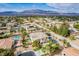 Aerial view of a two-story home, pool, tennis court, with desert landscaping in a beautiful community at 6214 Ebony Legends Ave, Las Vegas, NV 89131