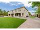 Expansive backyard with well manicured lawn, custom bar, and access to the home at 6214 Ebony Legends Ave, Las Vegas, NV 89131