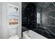 Modern bathroom with a black marble tiled shower and a view from the window at 6214 Ebony Legends Ave, Las Vegas, NV 89131