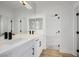 Modern bathroom featuring double sinks, white cabinets, and black hardware at 6214 Ebony Legends Ave, Las Vegas, NV 89131