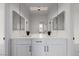 Bright bathroom featuring a double sink vanity with black fixtures and modern lighting at 6214 Ebony Legends Ave, Las Vegas, NV 89131