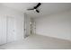 Carpeted bedroom featuring a ceiling fan and closet space at 6214 Ebony Legends Ave, Las Vegas, NV 89131