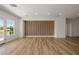 Spacious bonus room with wood look floors, white walls, and a unique decorative wood panel wall at 6214 Ebony Legends Ave, Las Vegas, NV 89131