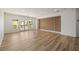 Bright and spacious bonus room with hardwood floors, a wall with vertical wood paneling, and French doors leading to a balcony at 6214 Ebony Legends Ave, Las Vegas, NV 89131