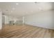 Large bonus room with wood look floors, recessed lighting, a decorative iron railing, and a modern chandelier at 6214 Ebony Legends Ave, Las Vegas, NV 89131