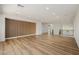 Large open bonus room with wood look floors, recessed lighting, white walls, and a vertical panel accent wall at 6214 Ebony Legends Ave, Las Vegas, NV 89131