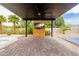 Outdoor entertainment area with covered pavilion and a tv at 6214 Ebony Legends Ave, Las Vegas, NV 89131