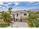 Beautiful two-story home with a three-car garage and desert landscaping at 6214 Ebony Legends Ave, Las Vegas, NV 89131