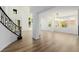 Welcoming foyer featuring grand staircase, high ceilings, and abundant natural light streaming through large windows at 6214 Ebony Legends Ave, Las Vegas, NV 89131