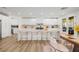 Contemporary kitchen with island seating, modern appliances, and an adjacent dining area at 6214 Ebony Legends Ave, Las Vegas, NV 89131