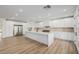 Bright, spacious kitchen features a large island, stainless steel appliances, and all-white cabinetry at 6214 Ebony Legends Ave, Las Vegas, NV 89131