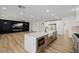 Spacious open-concept kitchen featuring a large island with waterfall countertop and modern appliances at 6214 Ebony Legends Ave, Las Vegas, NV 89131