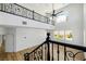 Open-concept living room with wood floors, white walls, and decorative black wrought iron banister at 6214 Ebony Legends Ave, Las Vegas, NV 89131