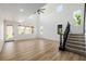 Bright, open living room with soaring ceilings and wrought iron staircase, filled with natural light at 6214 Ebony Legends Ave, Las Vegas, NV 89131