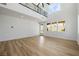 Spacious open-concept living area with wrought iron staircase, hardwood floors, and abundant natural light at 6214 Ebony Legends Ave, Las Vegas, NV 89131
