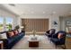Sophisticated living room featuring a modern accent wall, recessed lighting, and stylish furniture at 6214 Ebony Legends Ave, Las Vegas, NV 89131