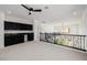 Open loft area with dark wet bar, black cabinets, and black iron railing at 6214 Ebony Legends Ave, Las Vegas, NV 89131
