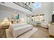 Bright main bedroom with a serene vibe featuring plush bedding and an abundance of natural light at 6214 Ebony Legends Ave, Las Vegas, NV 89131