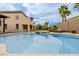 A luxurious backyard pool with a spa and fire pit provides a relaxing outdoor retreat at 6214 Ebony Legends Ave, Las Vegas, NV 89131