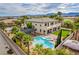Outdoor oasis showcasing a covered patio, lush lawn, and a sparkling pool with spa at 6214 Ebony Legends Ave, Las Vegas, NV 89131