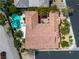 Aerial perspective of a private residence featuring a swimming pool, red car, and a well-maintained tile roof at 6227 Orto Vaso Ave, Las Vegas, NV 89131