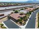 Property aerial showing the home's layout, tiled roof, and proximity to neighborhood and highway at 6227 Orto Vaso Ave, Las Vegas, NV 89131