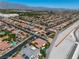 High angle aerial view of neighborhood with tile roofs, desert landscaping, and mountain views at 6227 Orto Vaso Ave, Las Vegas, NV 89131