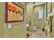 Charming half-bath featuring olive green walls, modern fixtures, and elegant artwork at 6227 Orto Vaso Ave, Las Vegas, NV 89131