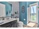 Bright bathroom featuring a walk-in shower and a door to the outside pool area at 6227 Orto Vaso Ave, Las Vegas, NV 89131